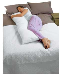 Woman resting with a white body pillow
